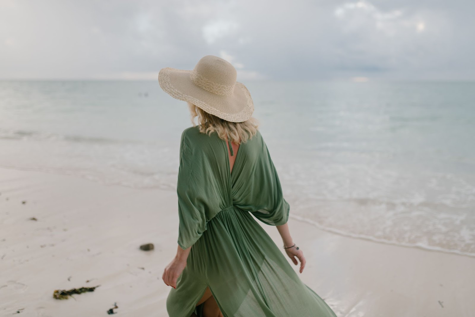 Woman walking alongside a seashore